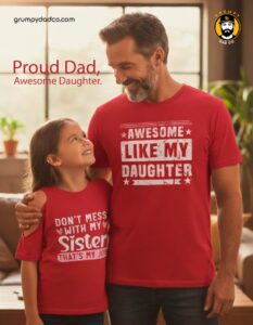 Dad and daughter wearing matching red shirts, smiling.