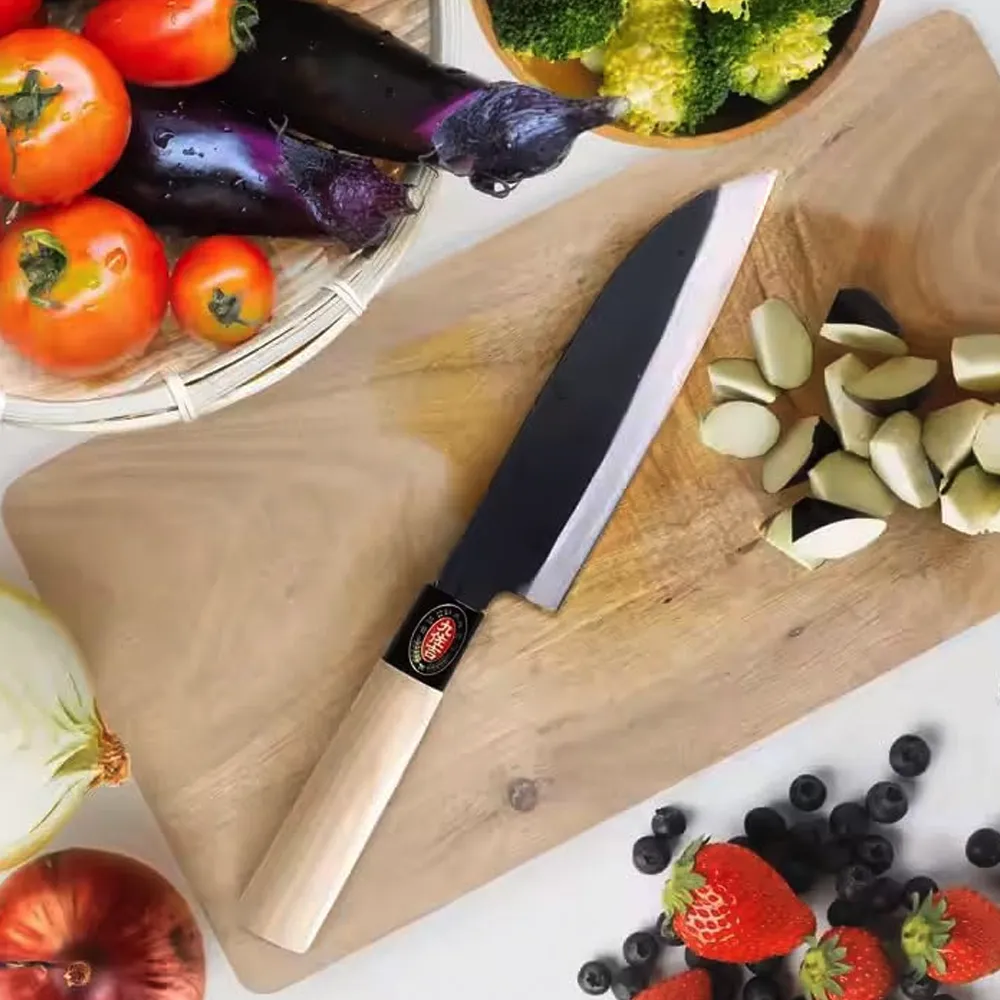 Knife and vegetables on wooden cutting board