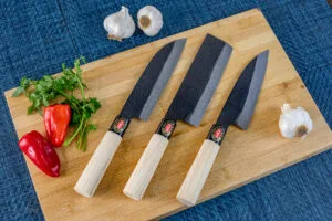 yoshida hamono 3 knife set on a cutting board