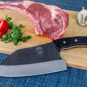 Steak, peppers, herbs, and knife on cutting board.