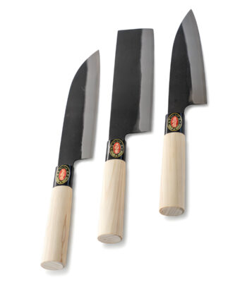 Three Japanese kitchen knives with wooden handles.