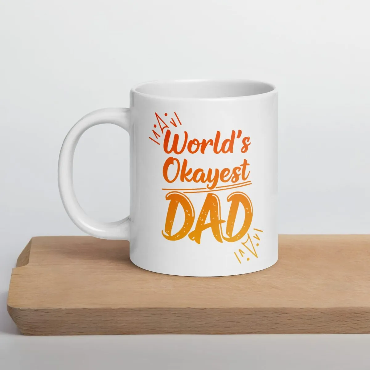 White ceramic mug with the phrase “World’s Okayest Dad” in bold black text – a funny and relatable gift for dads.