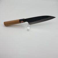 Japanese chef knife with wooden handle on stand.
