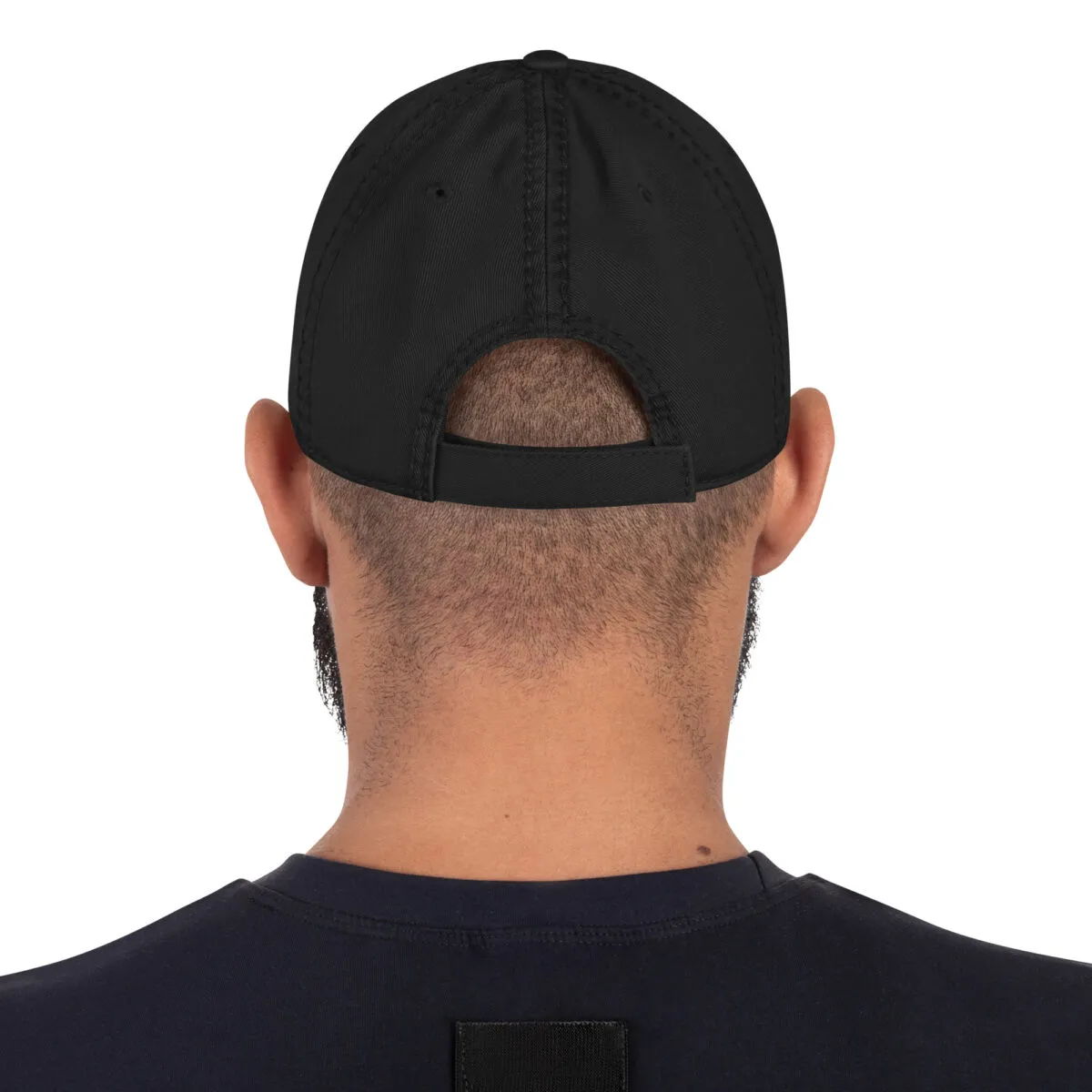 Back view of person wearing black baseball cap