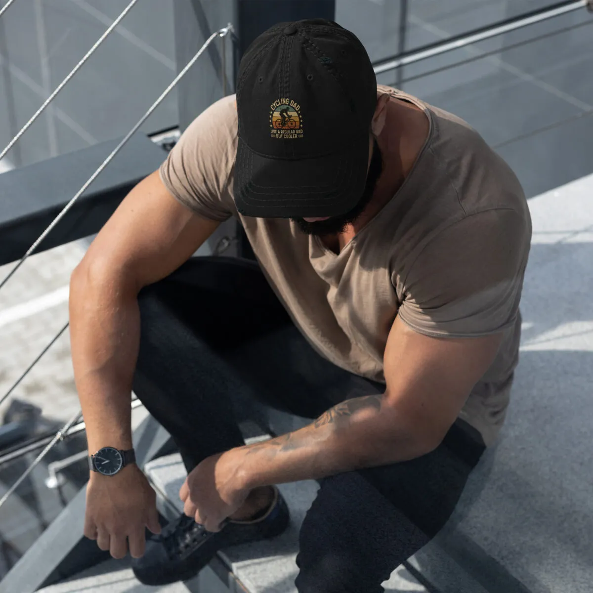 Man in cap sitting on stairs outdoors.
