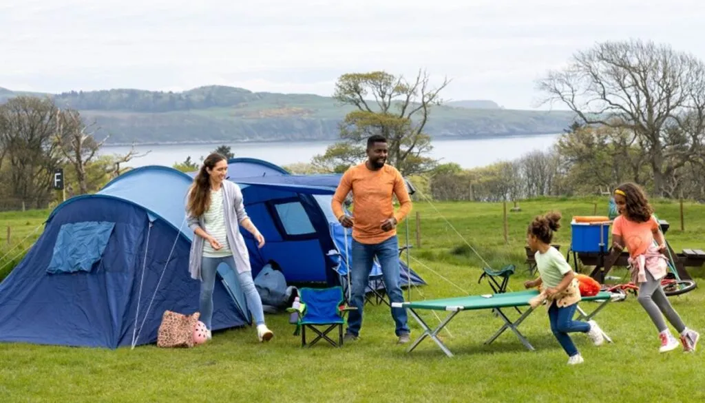 Family camping in scenic lakeside setting