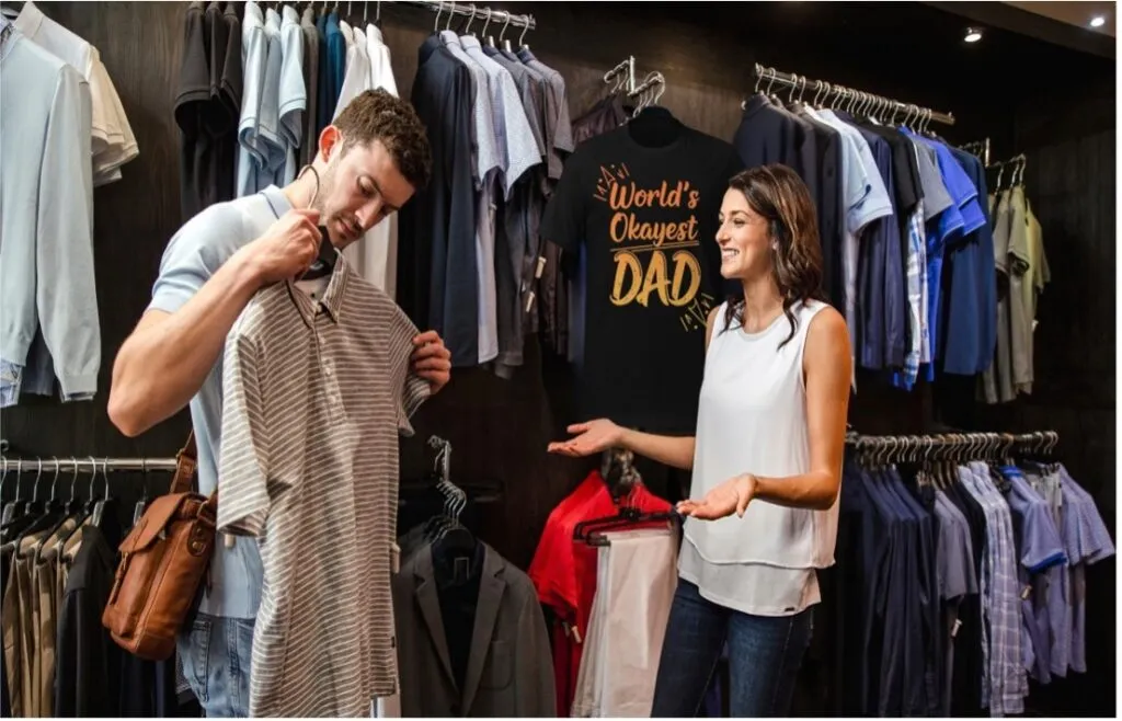 Man and woman choosing shirts in clothing store.