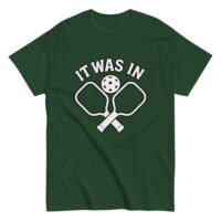 Green pickleball shirt with paddles and ball design.