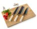Three knives on cutting board with vegetables