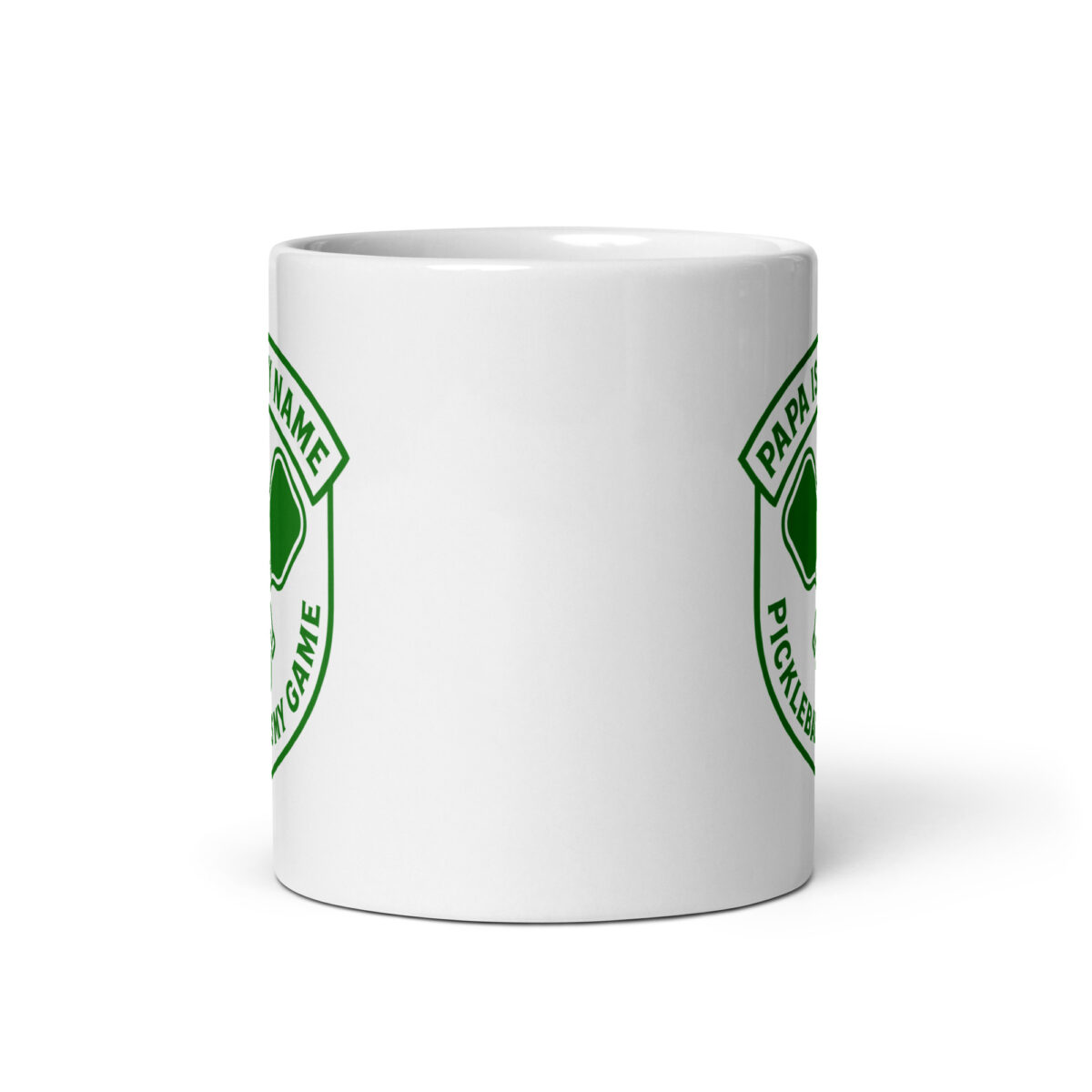 White mug with green pickleball design.