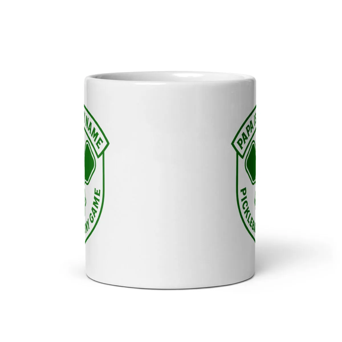 White mug with green pickleball design.