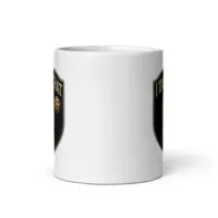 White mug with black and gold shield design.
