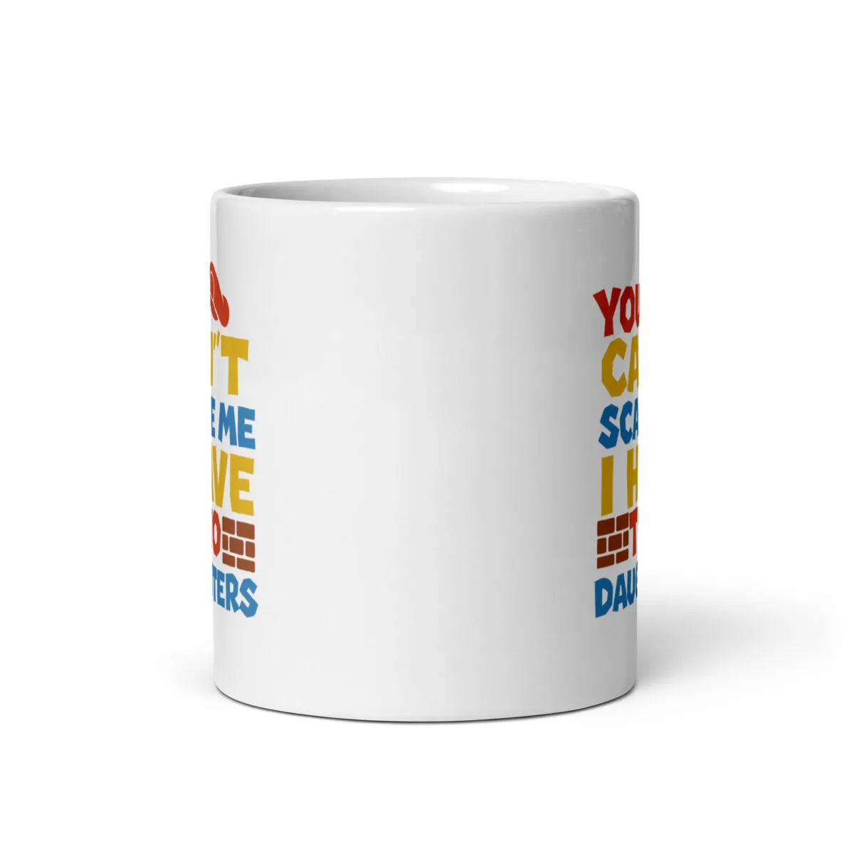 White mug with colorful text print.