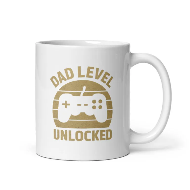 White mug with 'Dad Level Unlocked' design.