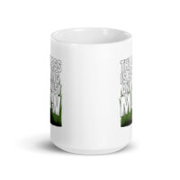 White mug with humorous grass mowing design.