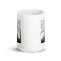 White mug with humorous grass mowing design.