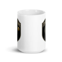 White mug with shield design and text