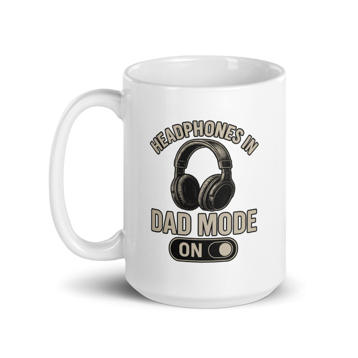 White mug with 'Headphones in Dad Mode' design.