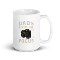 White mug with camera graphic and dad joke text.