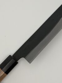 Close-up of Japanese knife on white background.
