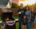 Family barbecue on Veterans Day with American flag.
