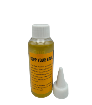 Bottle of camellia oil with applicator nozzle.