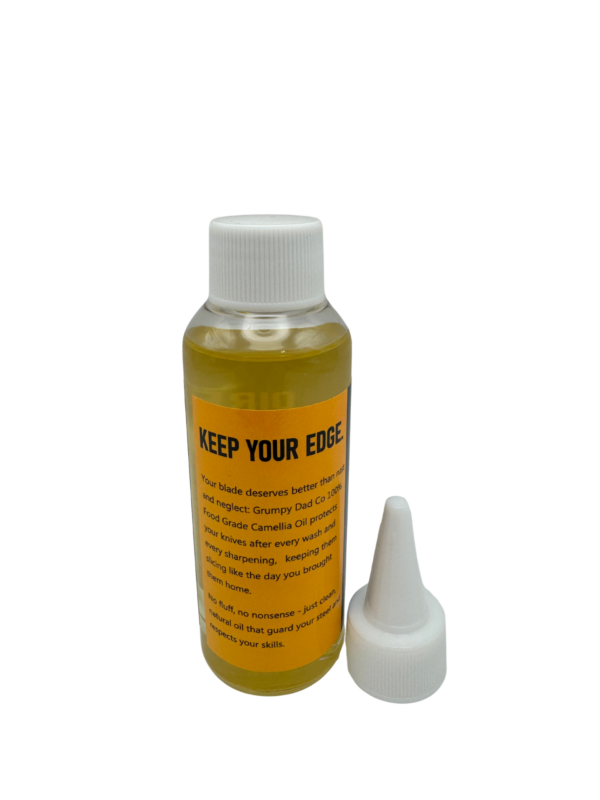 Bottle of camellia oil with applicator nozzle.