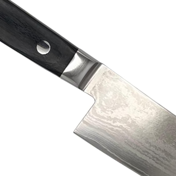 Close-up of a chef's knife blade and handle.