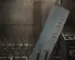 Chef's knife sitting in a dishwasher rack with steam, water spots, and faint discoloration on the blade
