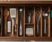 Organized kitchen drawer with 12 essential cooking tools arranged in a wooden divider